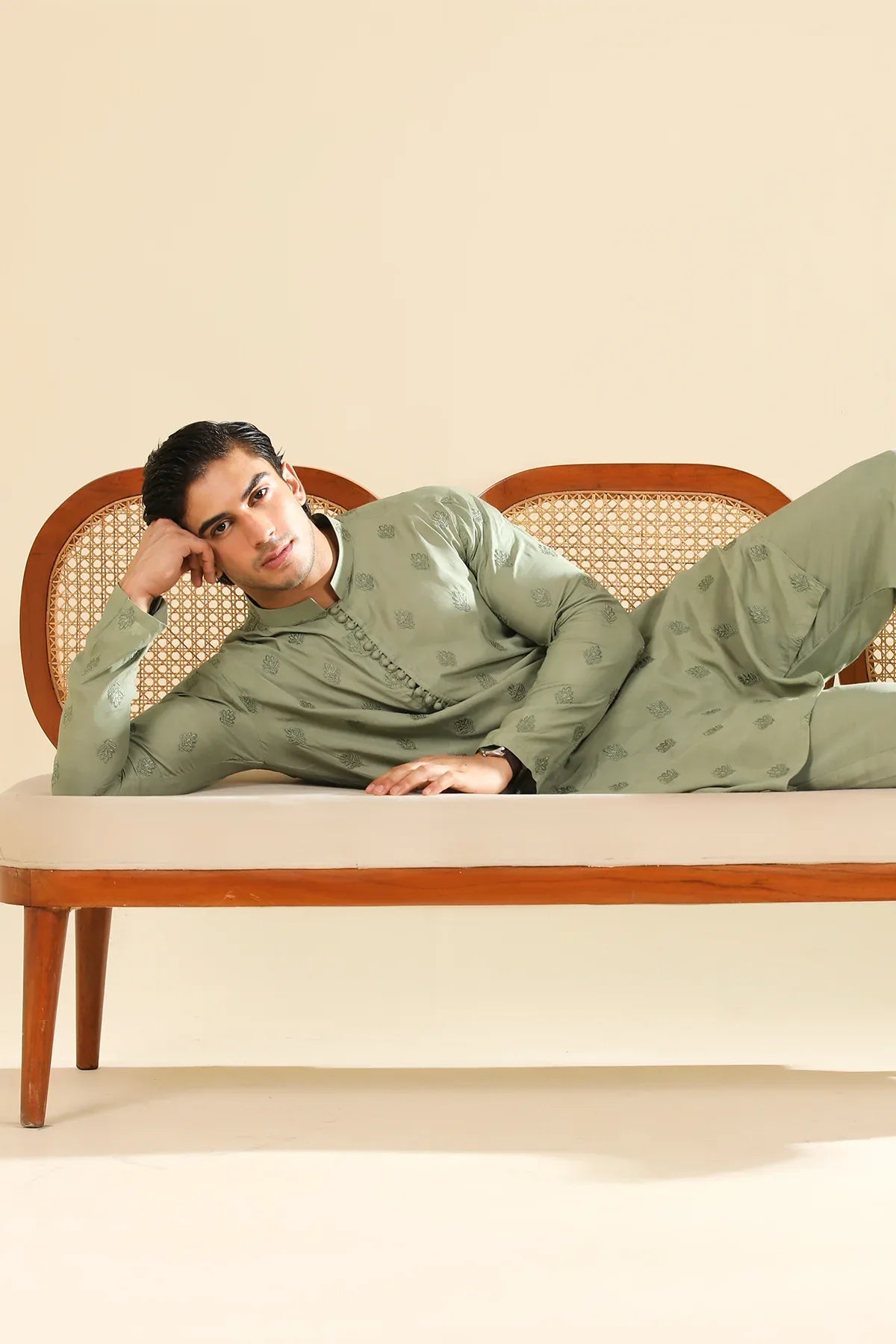 Man wearing a light green raw silk embroidered kurta with a beige backgroung