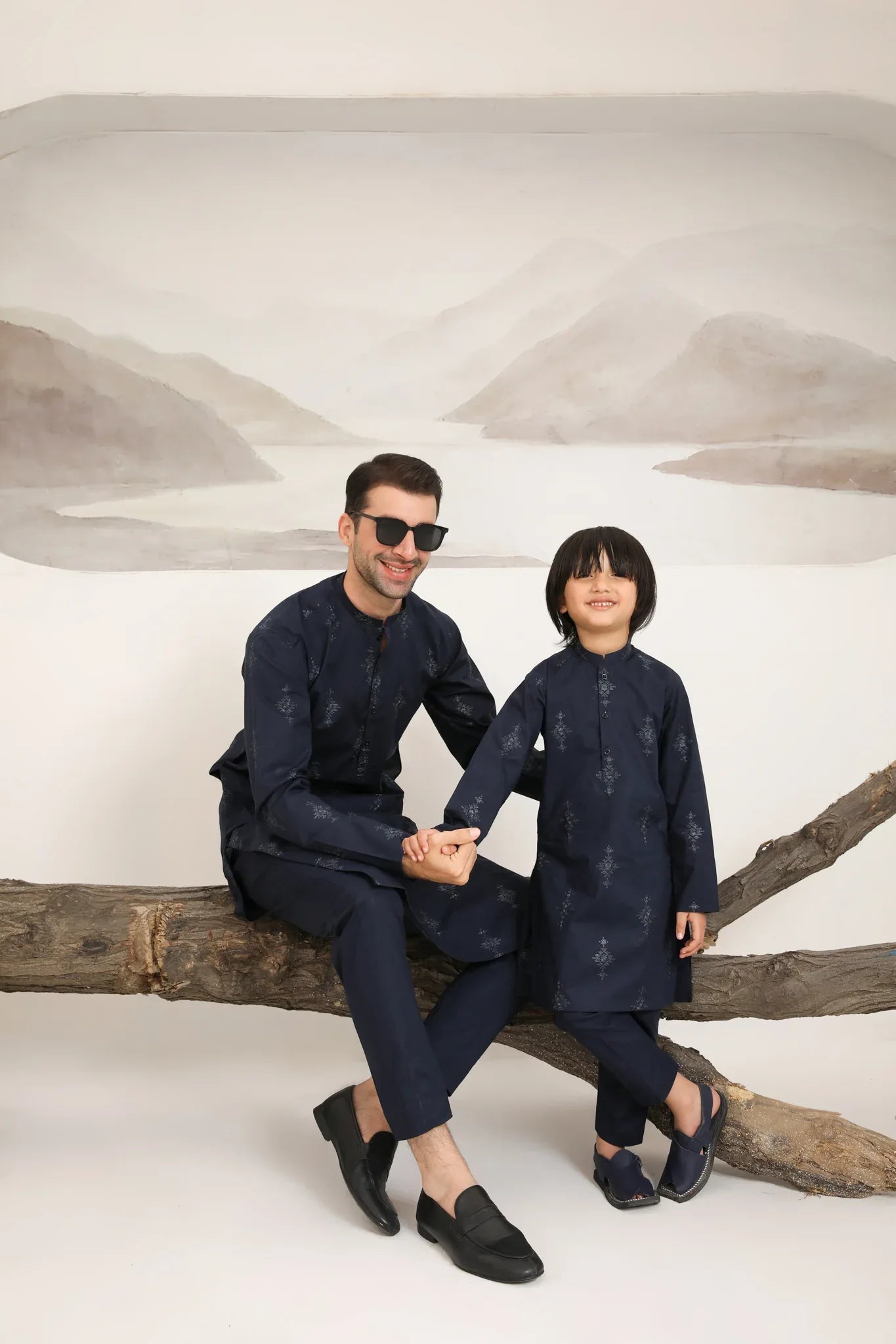 Father and son wearing same navy blue cotton embroidered kurta trouser