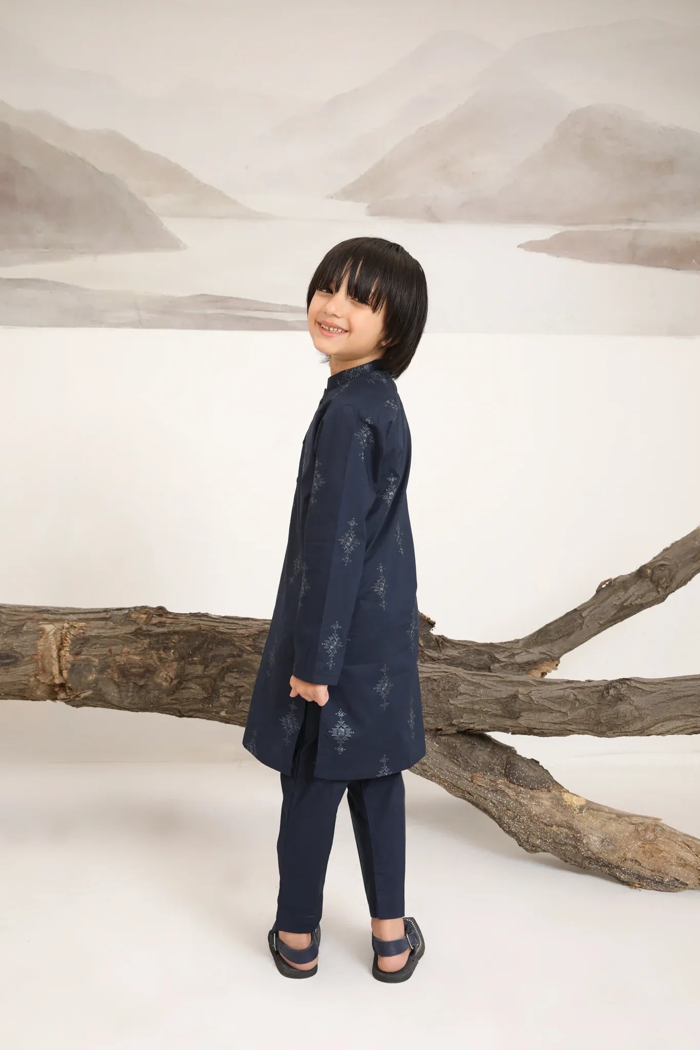 A child wearing a navy blue cotton embroidered kurta trouser