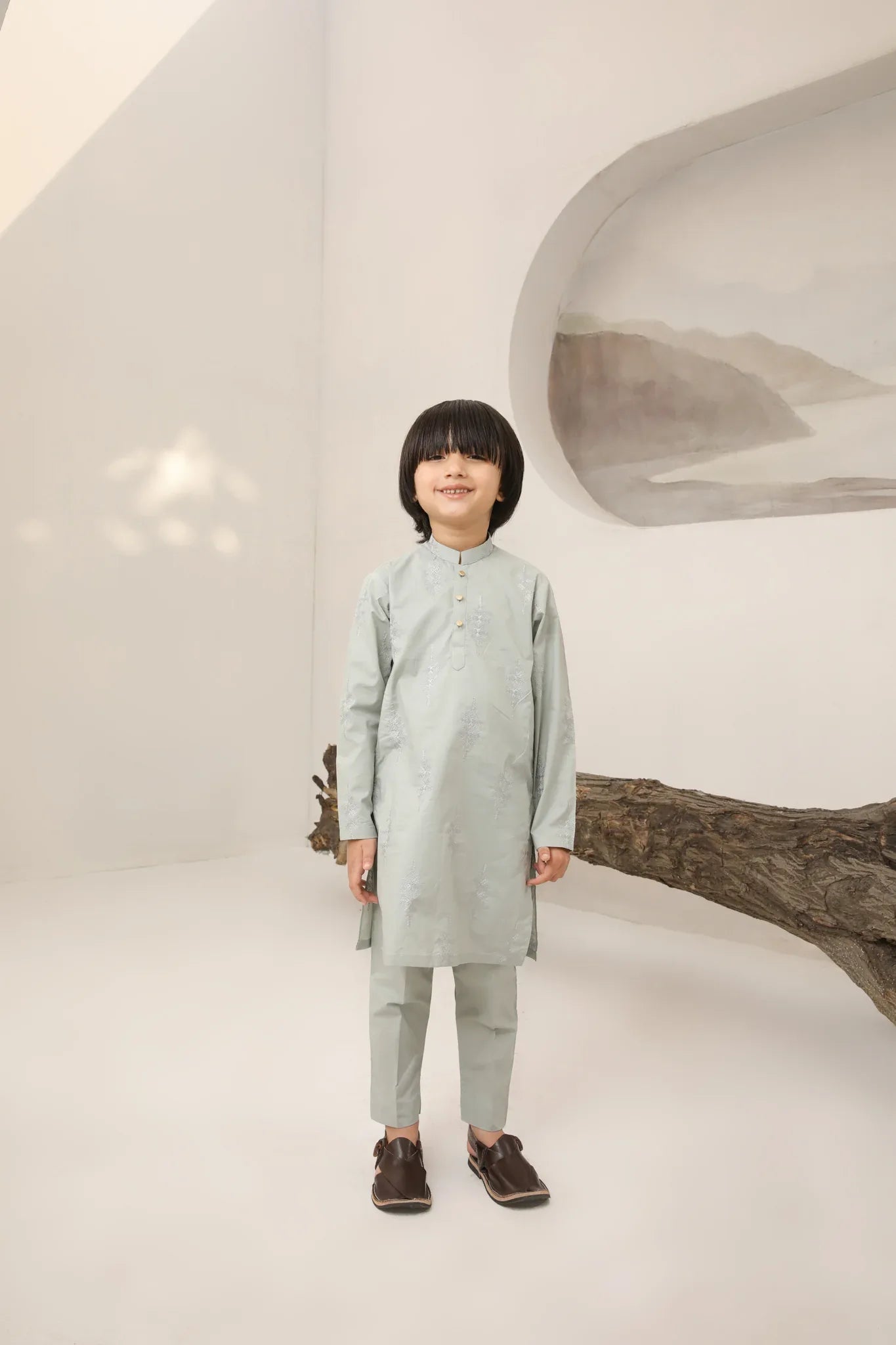 A child wearing a light mint soft cotton embroidered kurta trouser