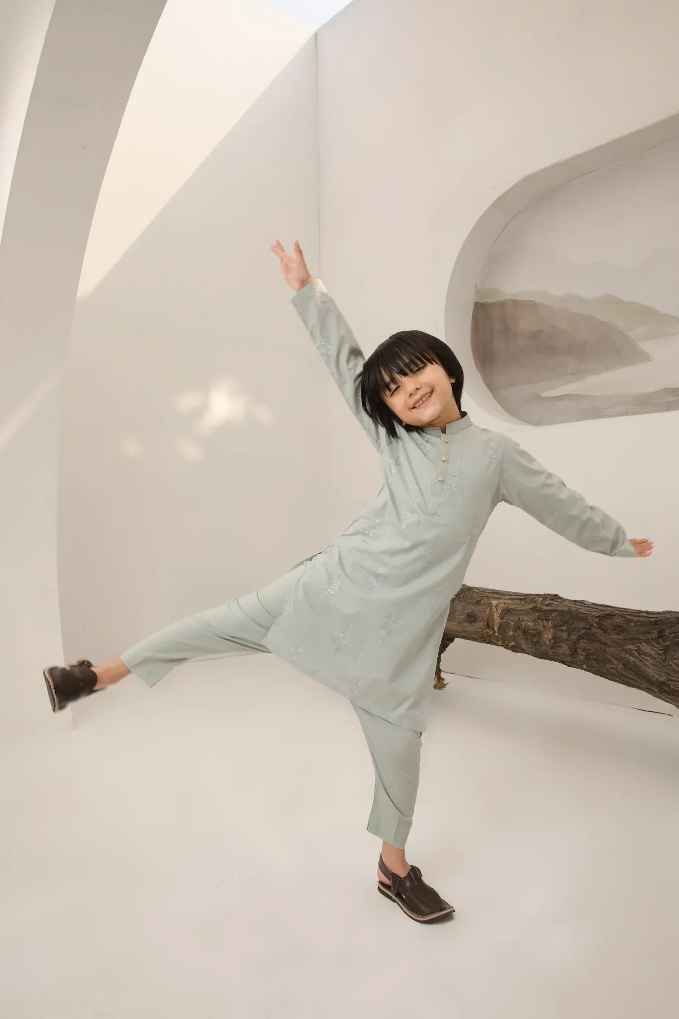 A child wearing a light mint soft cotton embroidered kurta trouser