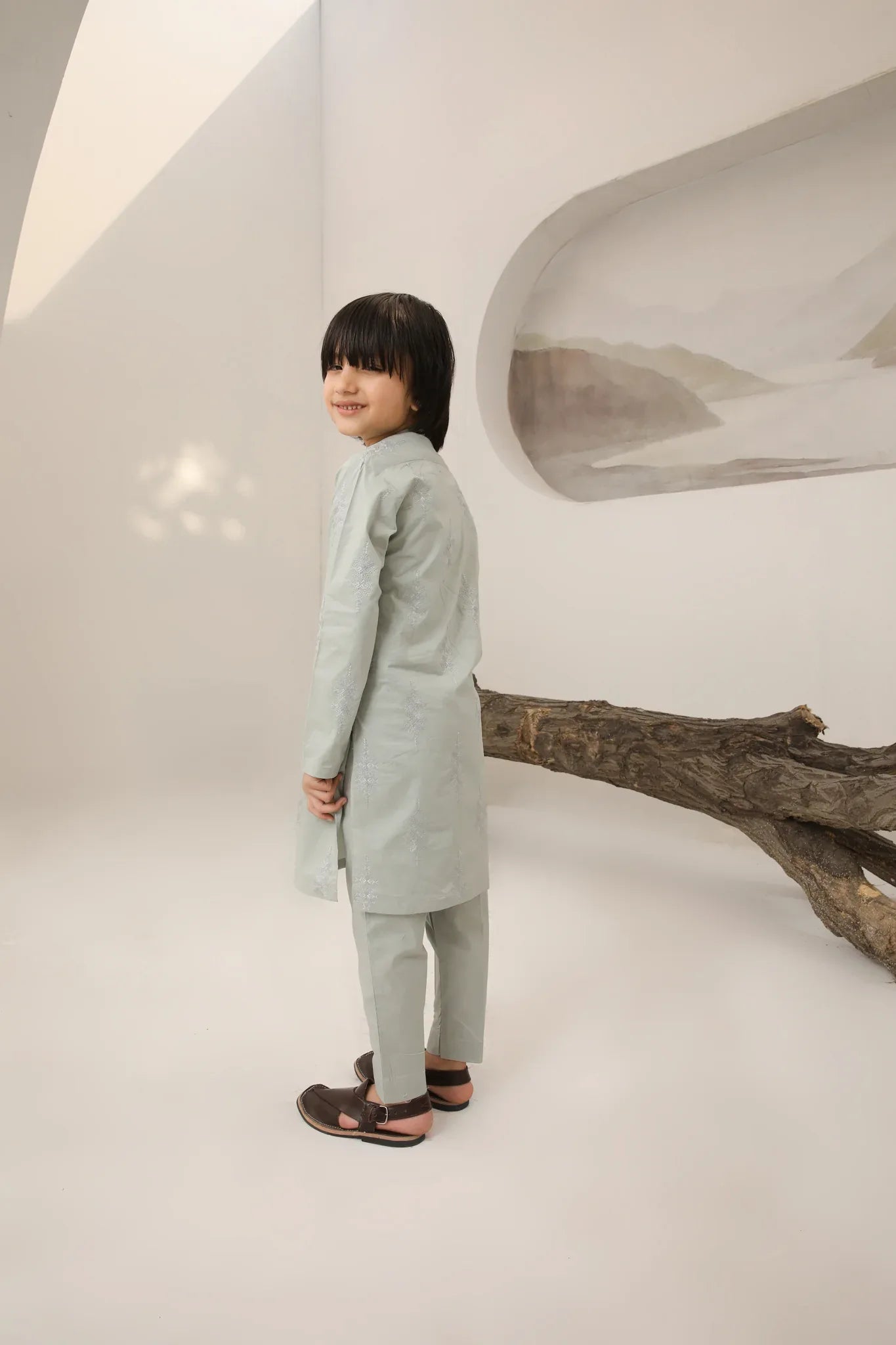 A child wearing a light mint soft cotton embroidered kurta trouser