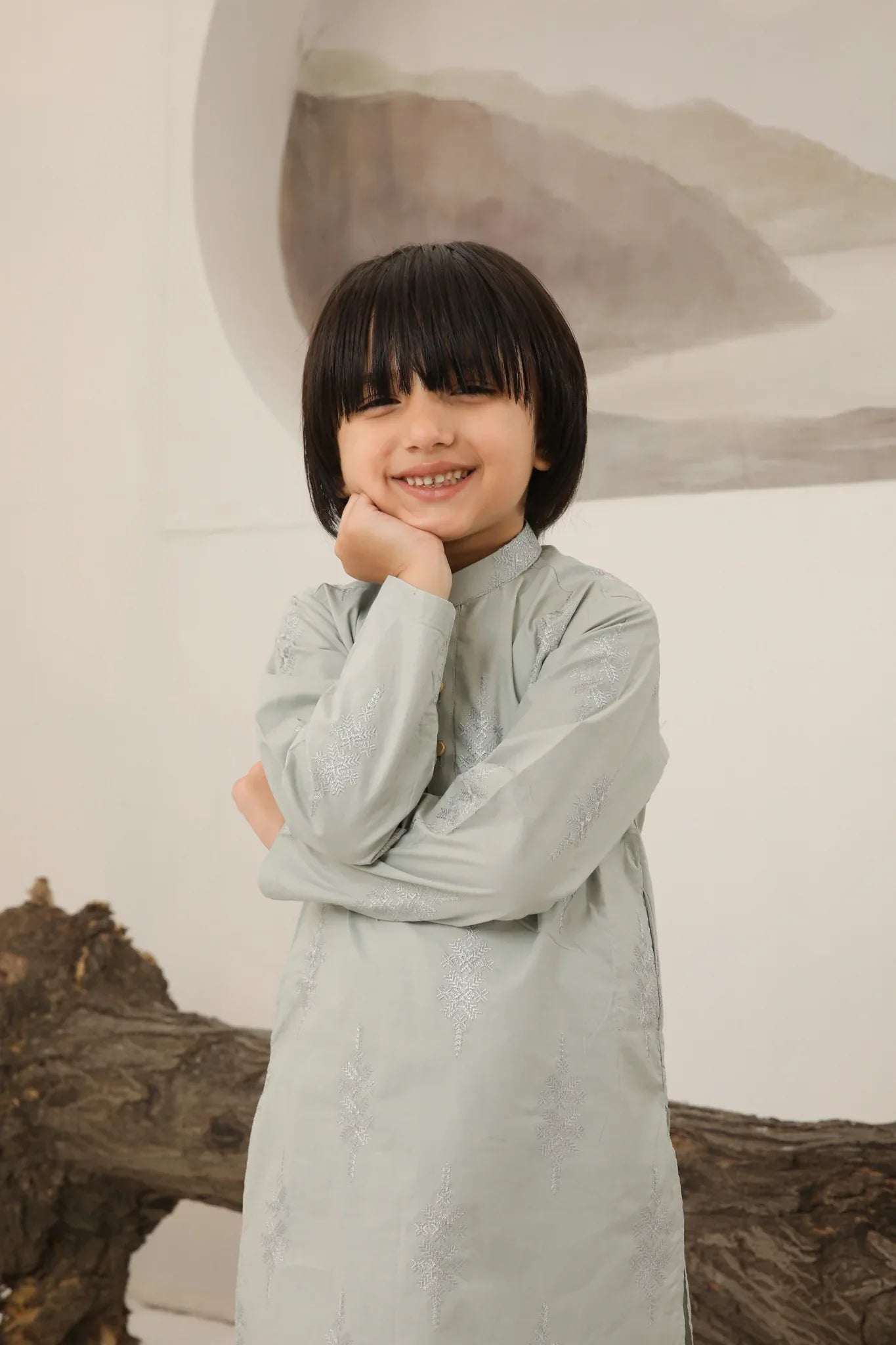 A child wearing a light mint soft cotton embroidered kurta trouser