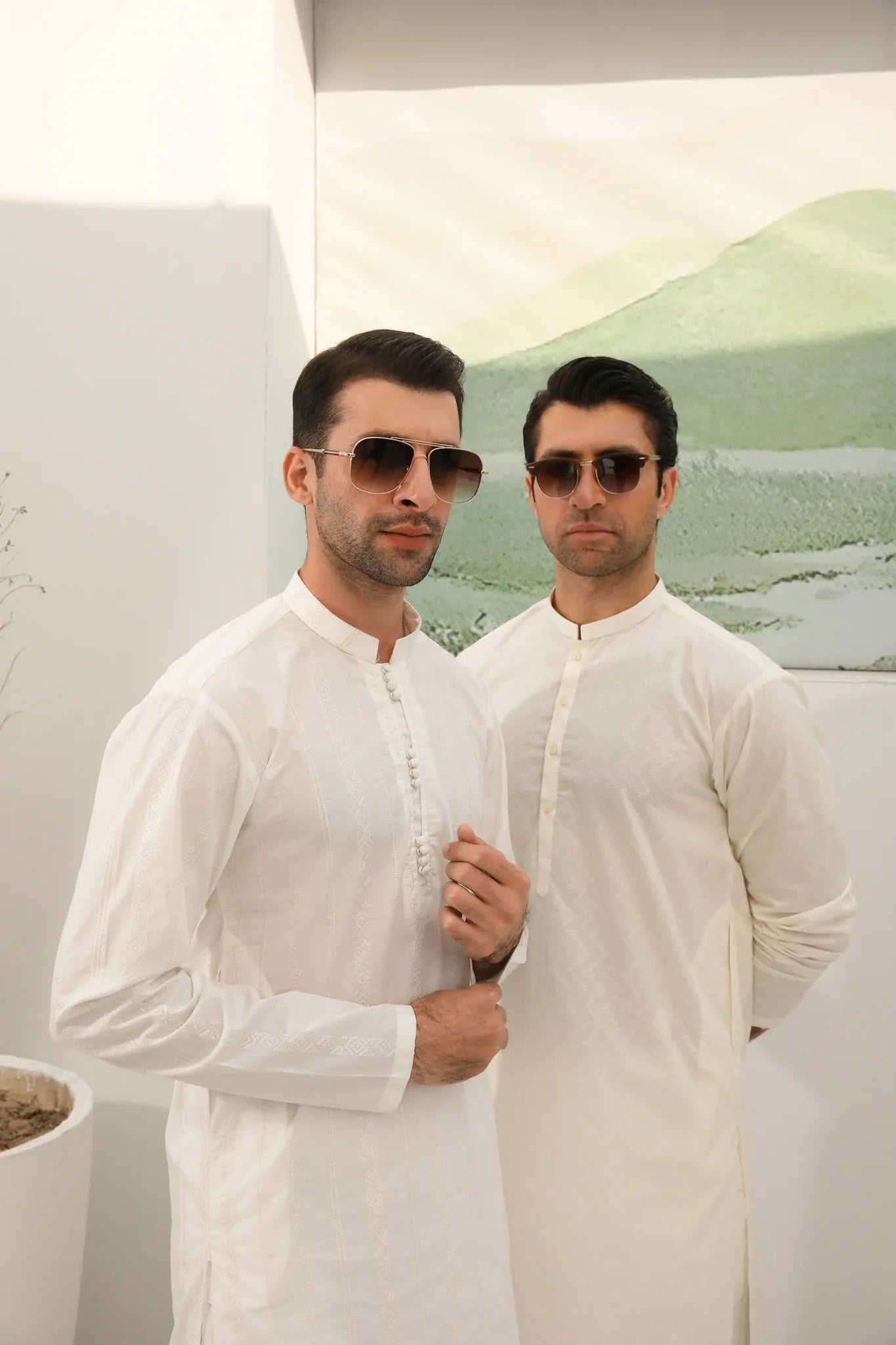 A man wearing a white embroidered kurta trouser with full sleeves in soft cotton fabric.