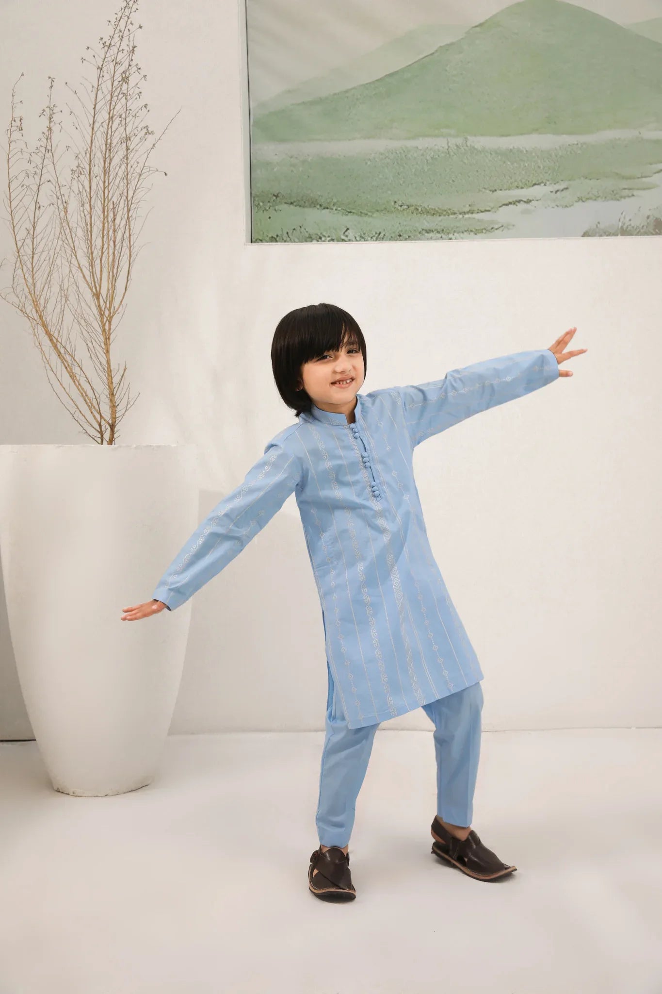 A child wearing a sky blue cotton embroidered kurta trouser